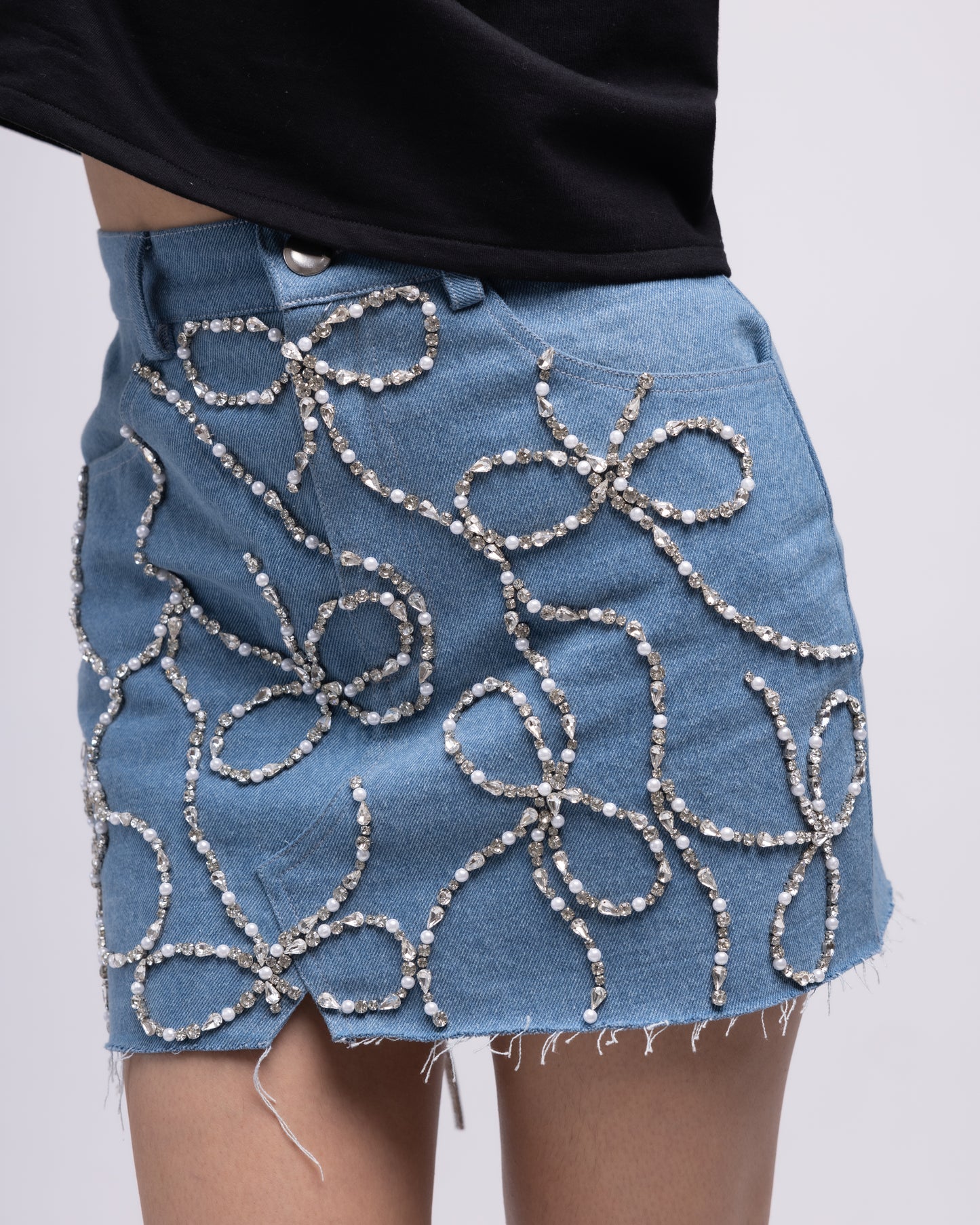 Denim mini skirt with embellished bows