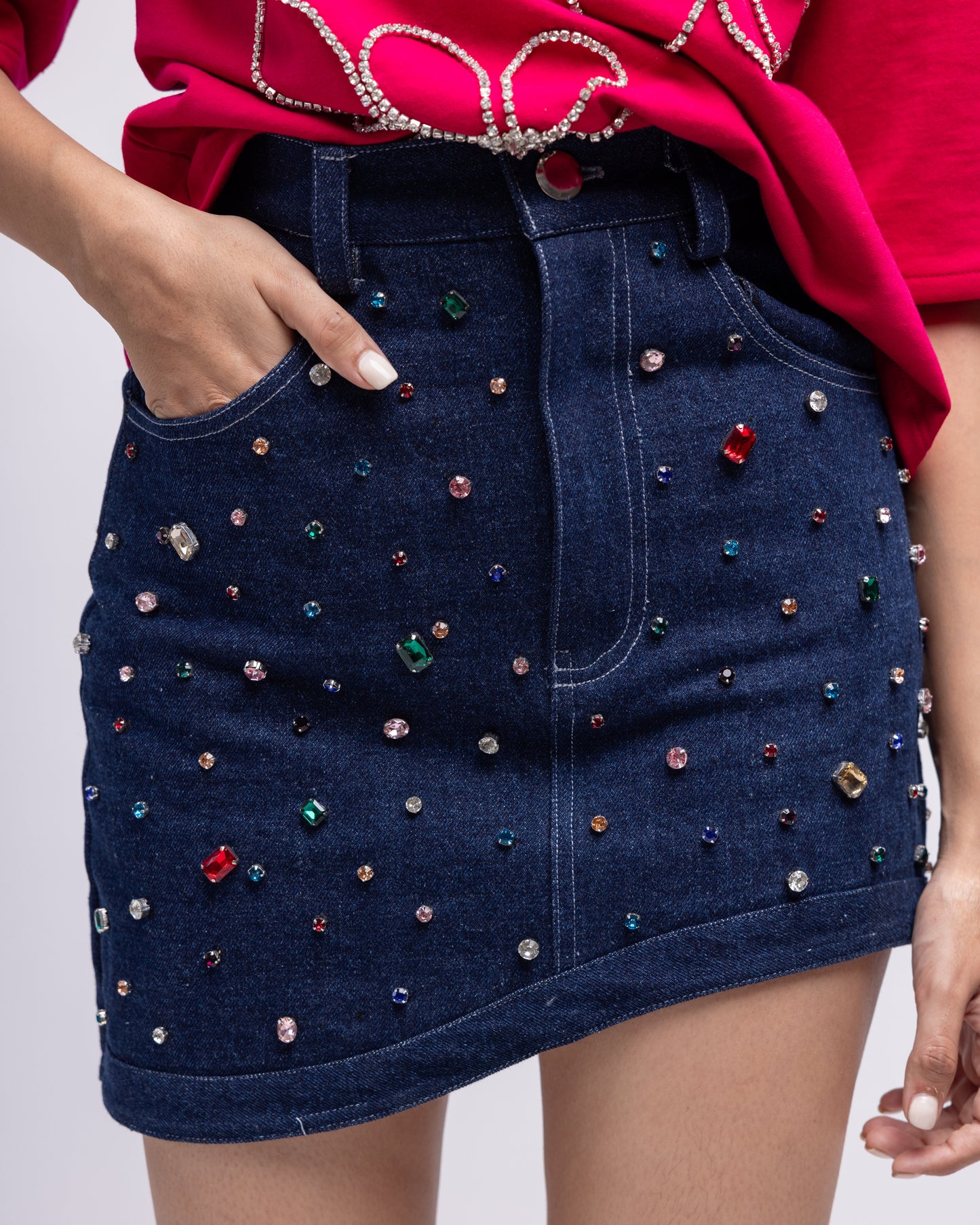 Asymmetric denim mini skirt with multi-colour embellishment