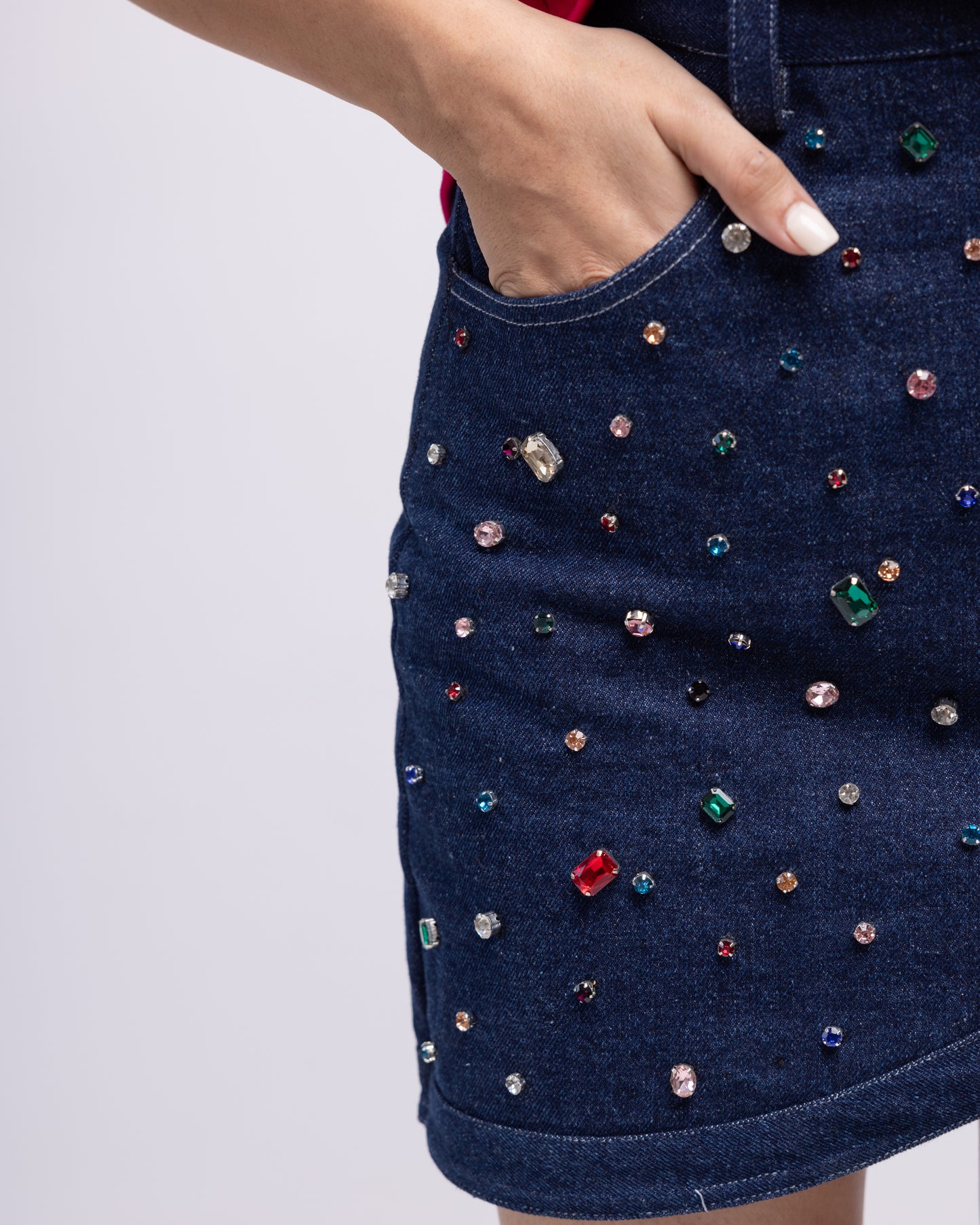 Asymmetric denim mini skirt with multi-colour embellishment